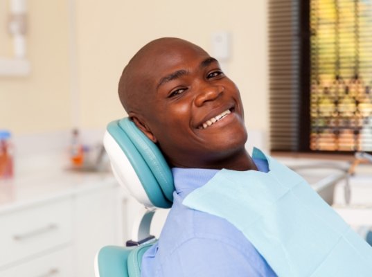 Smiling man leaning back in dental chair