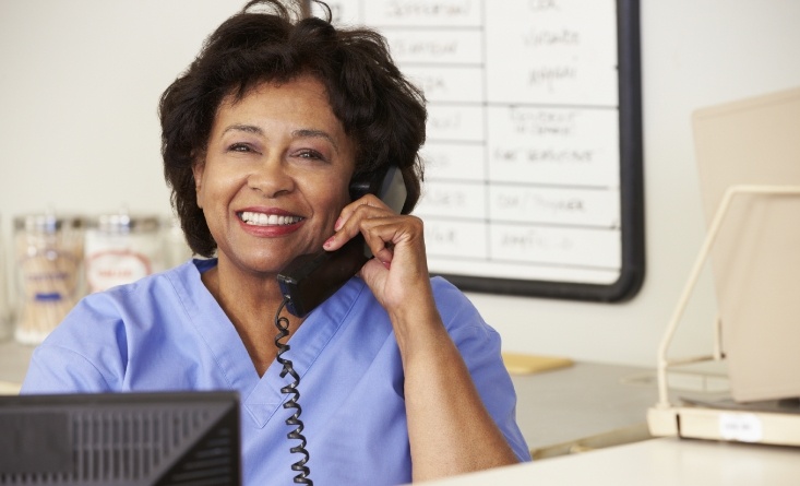 Smiling dental team member talking on the phone