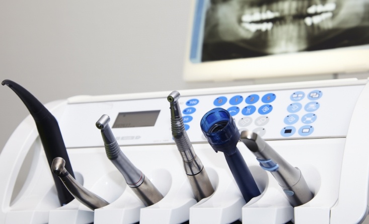 Several dental technologies with X rays of teeth in background