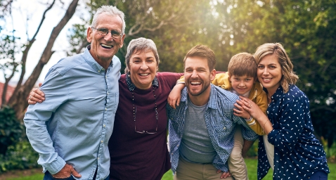 Family of five smiling outdoors