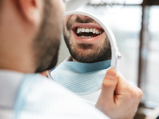 Patient looking at smile in reflection