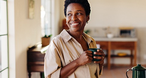 Smiling woman enjoying coffee at home