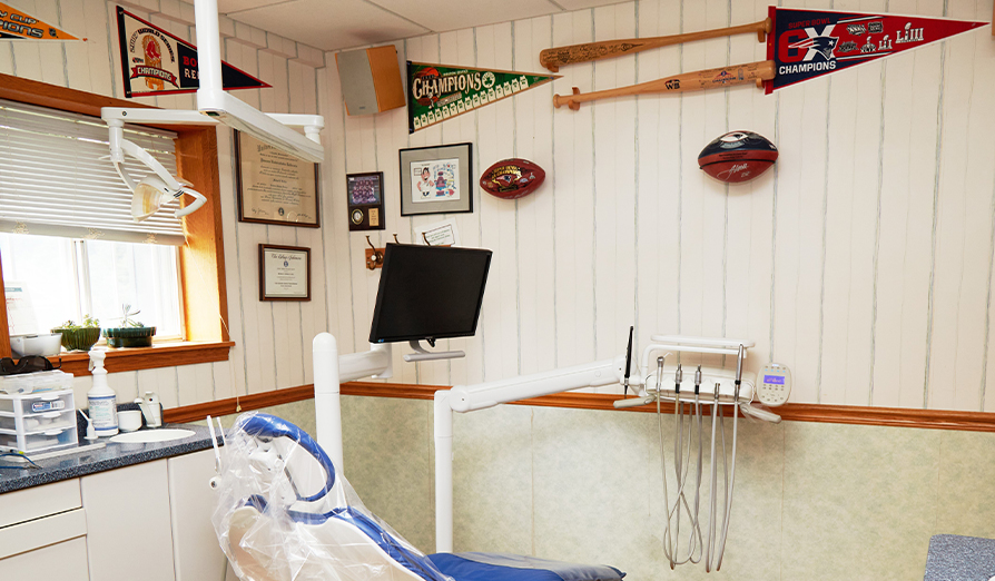 Dental treatment room with sports memorabilia on walls