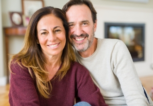 Man and woman smiling together on couch