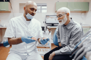 a patient and their dentist talking about dentures 