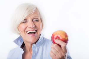 a patient with dentures eating